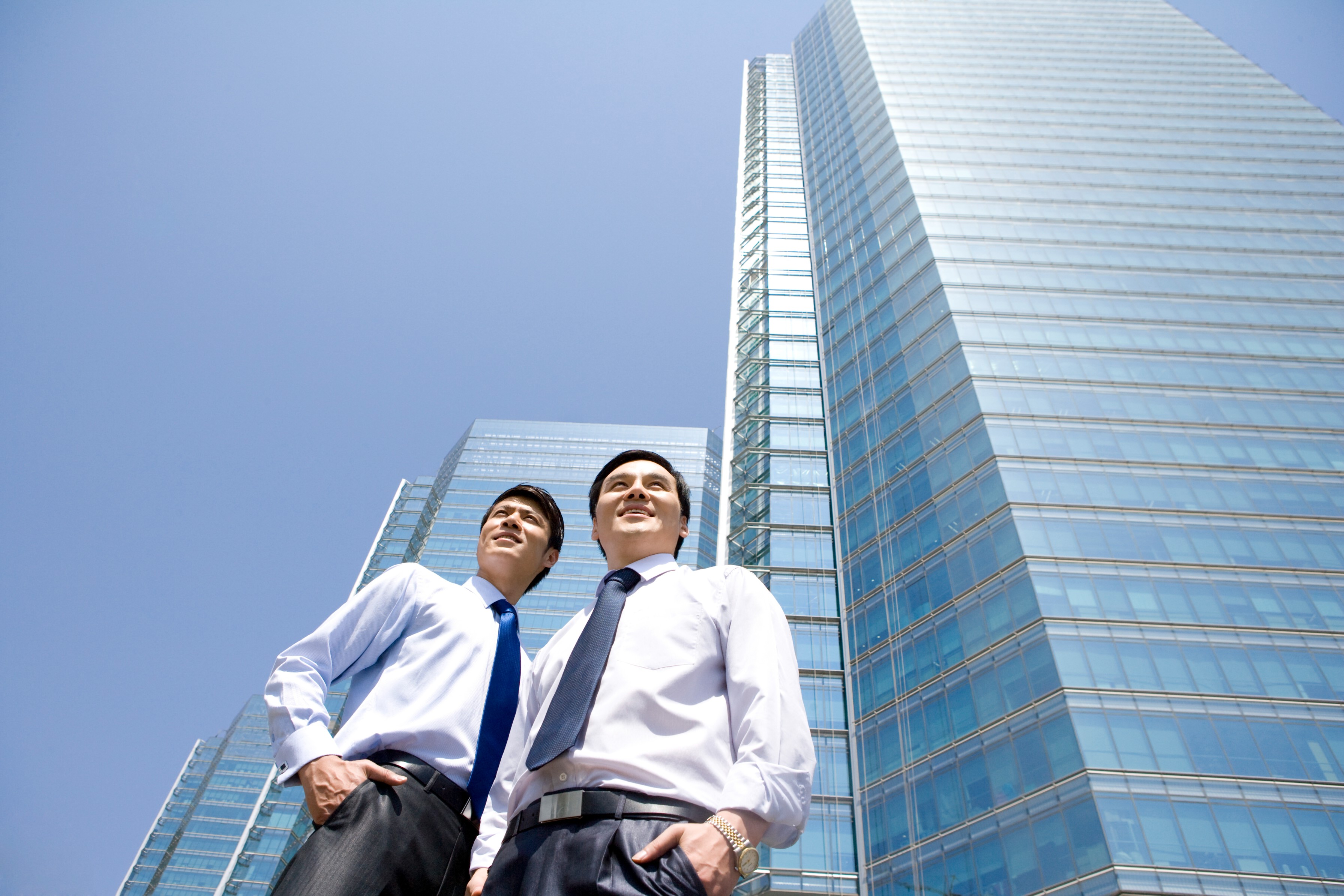 Two investors visiting a commercial property they partially own through fractional ownership